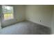 Well-lit bedroom featuring neutral walls, base trim, and a bright window view at 6049 Hodges Rd., Conway, SC 29527