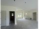 Spacious living room with neutral walls, base trim, and multiple doorways at 6049 Hodges Rd., Conway, SC 29527