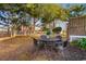 Cozy backyard with dining set and shade trees, perfect for outdoor gatherings at 616 36Th Ave. S, North Myrtle Beach, SC 29582