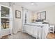 Bright bedroom featuring two windows, decor with a coastal theme, and hardwood floors at 616 36Th Ave. S, North Myrtle Beach, SC 29582