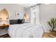 Well-lit bedroom showcasing bed with decorative pillows and leafy accents at 616 36Th Ave. S, North Myrtle Beach, SC 29582