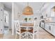 Cozy dining area featuring a round wooden table, rattan pendant light, and access to the kitchen at 616 36Th Ave. S, North Myrtle Beach, SC 29582