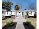 Charming white home with a modern boardwalk style front entrance and blue front door at 616 36Th Ave. S, North Myrtle Beach, SC 29582