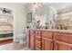 Bathroom features a double sink vanity with granite counters and wood cabinets at 704 Compass Pointe Dr, North Myrtle Beach, SC 29582