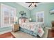 Light-filled bedroom with vaulted ceiling, coastal decor, large windows, and a comfortable bed and side tables at 704 Compass Pointe Dr, North Myrtle Beach, SC 29582