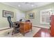 Cozy home office with a wooden desk, ergonomic chair, and natural light from a window with shutters at 704 Compass Pointe Dr, North Myrtle Beach, SC 29582