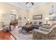 Beautiful living room featuring a large rug, comfortable seating, and an open floor plan into the dining area at 704 Compass Pointe Dr, North Myrtle Beach, SC 29582