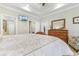 Bright main bedroom with a decorative tray ceiling, a mounted television, and a large wooden dresser at 704 Compass Pointe Dr, North Myrtle Beach, SC 29582