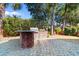 Outdoor kitchen featuring a built-in grill, brick surround, and paved patio space at 704 Compass Pointe Dr, North Myrtle Beach, SC 29582