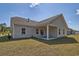 Exterior view of the back of the house with a covered patio, well maintained backyard at 7059 Shady Grove Rd., Conway, SC 29527