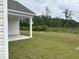 This home's covered patio offers a tranquil view of the lush, sprawling backyard at 7059 Shady Grove Rd., Conway, SC 29527
