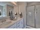 Bathroom featuring a double granite vanity and a glass-enclosed shower at 7059 Shady Grove Rd., Conway, SC 29527