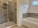 Bathroom featuring a glass door shower and soaking tub with tile surround at 7059 Shady Grove Rd., Conway, SC 29527