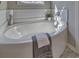 View of a clean and simple bathtub with a candle and a plant, and gray towels at 7059 Shady Grove Rd., Conway, SC 29527