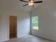 Spacious bedroom with hardwood flooring, ceiling fan, closet, and a window at 7059 Shady Grove Rd., Conway, SC 29527