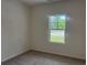 Cozy bedroom with neutral carpeting, a window offering outdoor views, and ample natural light at 7059 Shady Grove Rd., Conway, SC 29527