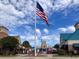 Attractive community with storefronts under a bright blue sky waving the American flag at 7059 Shady Grove Rd., Conway, SC 29527