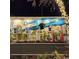 Festive night view of a downtown mural with string lights on a tree enhancing its charm at 7059 Shady Grove Rd., Conway, SC 29527