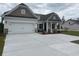 Stylish home features a spacious two-car garage and a meticulously maintained front yard at 7059 Shady Grove Rd., Conway, SC 29527