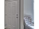 White door and gray arm chair with tufted buttons at 7059 Shady Grove Rd., Conway, SC 29527