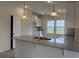 Bright kitchen features a granite countertop island with pendant lighting and modern fixtures at 7059 Shady Grove Rd., Conway, SC 29527
