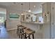 View of the kitchen bar featuring pendant lights, wooden stools, and white countertops at 7059 Shady Grove Rd., Conway, SC 29527