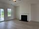 Open-concept living room with hardwood flooring, a fireplace, and sliding glass doors at 7059 Shady Grove Rd., Conway, SC 29527