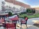 Outdoor area with red tables and chairs surrounded by landscaped garden with black and white train mural at 7059 Shady Grove Rd., Conway, SC 29527