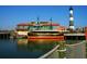 Waterfront view of a building and docked boat, complete with a lighthouse in the background at 7059 Shady Grove Rd., Conway, SC 29527