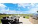 Outdoor dining area with table, chairs, grill, and views of the pond and fountain at 763 St. Vincent Loop, Little River, SC 29566