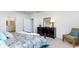 Well-lit main bedroom boasting an elegant dresser, chair, and patterned bedding at 8051 Bear Claw Ct., Conway, SC 29526