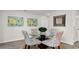 Bright dining area featuring a round glass table, patterned chairs, and modern floral artwork at 8054 Bear Claw Ct., Conway, SC 29526