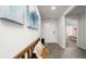 Bright entryway featuring modern art, a wooden bench, and views into the adjacent bedroom at 8054 Bear Claw Ct., Conway, SC 29526