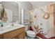 Bright bathroom featuring a single sink, patterned shower curtain and cabinet over the toilet at 825 Payne Ct., Conway, SC 29526