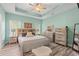 Light-filled bedroom with trey ceiling, features a decorative ceiling fan, and neutral tones at 825 Payne Ct., Conway, SC 29526
