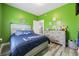 Bedroom featuring bright green walls, wood-look floors, and stylish dinosaur decor at 825 Payne Ct., Conway, SC 29526