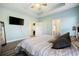 Bedroom with ensuite featuring light blue walls, wood look floors and tray ceiling at 825 Payne Ct., Conway, SC 29526