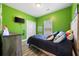 Vibrant green bedroom features ample natural light, creating a lively atmosphere at 825 Payne Ct., Conway, SC 29526