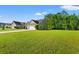 Exterior view of home with a large manicured lawn and paved driveway leading to the attached garage at 825 Payne Ct., Conway, SC 29526
