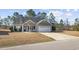 Charming single-story home with a well-manicured front yard and a two-car garage at 825 Payne Ct., Conway, SC 29526