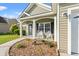 Charming front porch with rocking chairs and decorative landscaping enhancing the curb appeal of the home at 825 Payne Ct., Conway, SC 29526