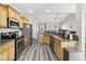 Kitchen featuring stainless steel appliances, wooden cabinetry, and gray vinyl floors at 825 Payne Ct., Conway, SC 29526