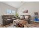 Cozy living room featuring plush sofas, rustic coffee table, and ample natural light, perfect for relaxation and comfort at 825 Payne Ct., Conway, SC 29526