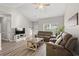 Inviting living room with vaulted ceiling, wood flooring, and a large window offering ample natural light at 825 Payne Ct., Conway, SC 29526