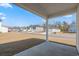 View from covered back patio showcasing backyard and view of neighborhood street at 8500 Dunes Point Way, Longs, SC 29568