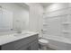 Well-lit bathroom showcasing vanity and tub with shower head at 8500 Dunes Point Way, Longs, SC 29568