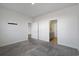 Neutral bedroom with gray carpet, white walls, closet and bathroom door at 8500 Dunes Point Way, Longs, SC 29568