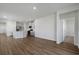 Open floor plan with hard surface floors connecting the living room to the kitchen at 8500 Dunes Point Way, Longs, SC 29568