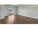 Living room with hard surface flooring, neutral walls, and sliding glass door at 8500 Dunes Point Way, Longs, SC 29568