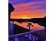 Scenic backyard with a water view, palm tree, and colorful sunset sky seen from the balcony at 949 Crystal Water Way, Myrtle Beach, SC 29579